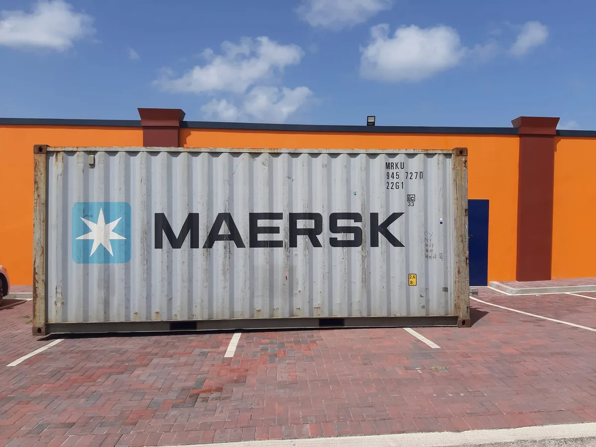 A shipping container of imported building materials delivered on site in Aruba